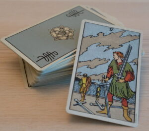 Tarot Deck Five of Swords scaled e1718508430911 300x264 - 2025 Psychic Astrology Predictions